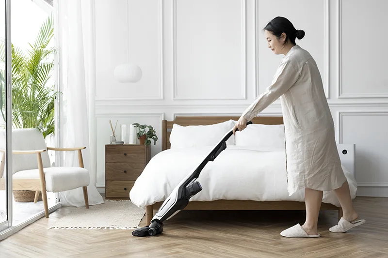 woman-vacuuming-her-bedroom